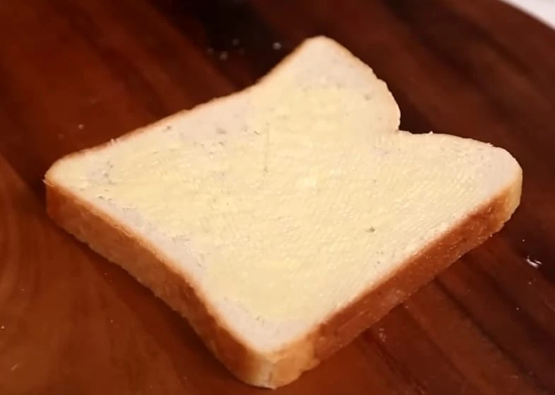 applying butter on bread