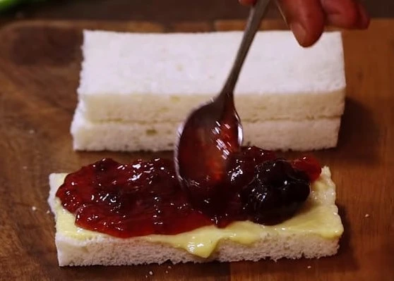 applying jam on sandwich