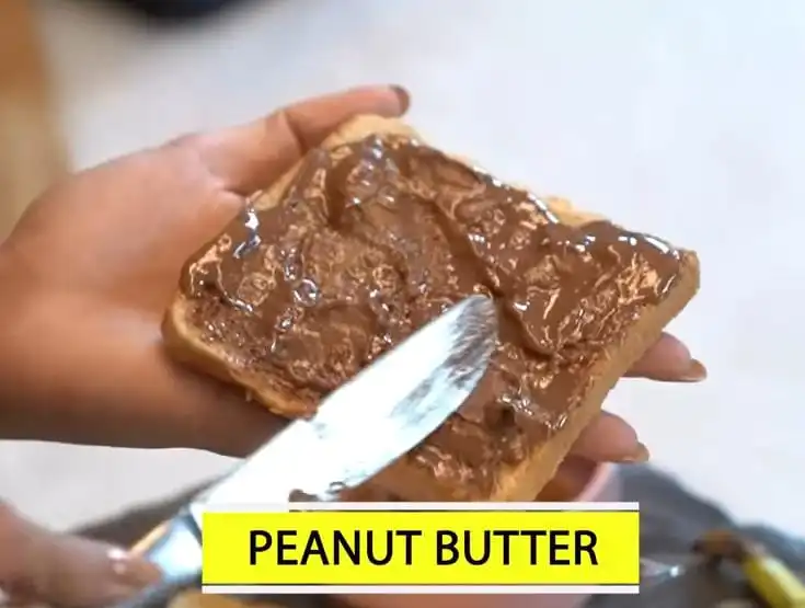 applying peanut butter on sandwich