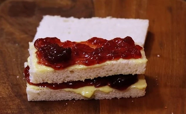 assembling jam butter sandwich