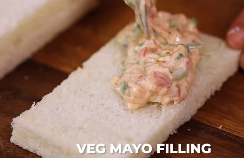 spreading mayo filling on bread