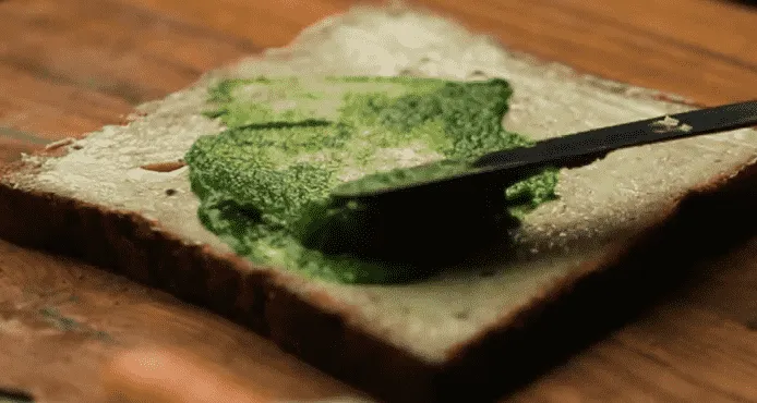 apply green sauce on bread slice