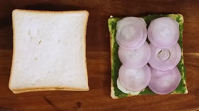 placing onion on sandwich