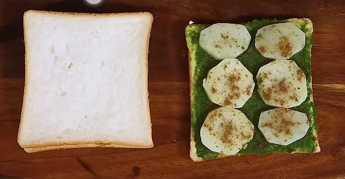 spreading masala powder on sandwich