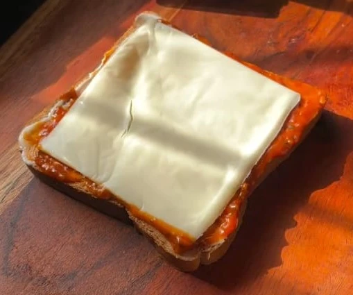 placing the cheese slice over bread