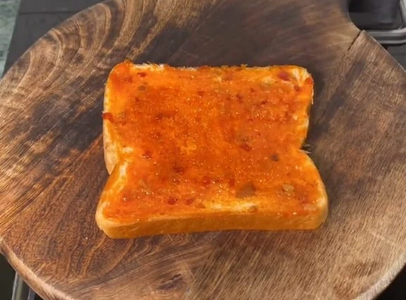 spread schezan chutney on bread