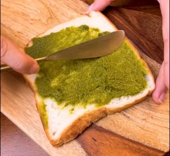 Apply green chutney on bread