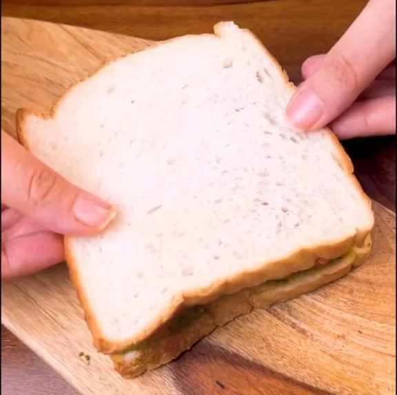 closing the sandwich with another bread slice