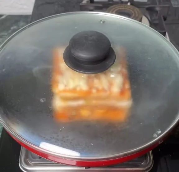 place the lid of pan on it