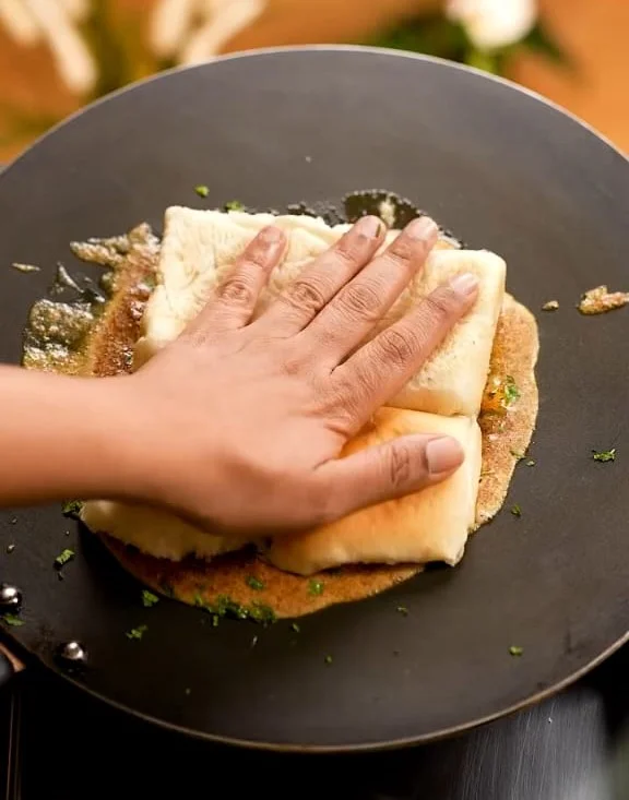 placing pav on tawa for cooking